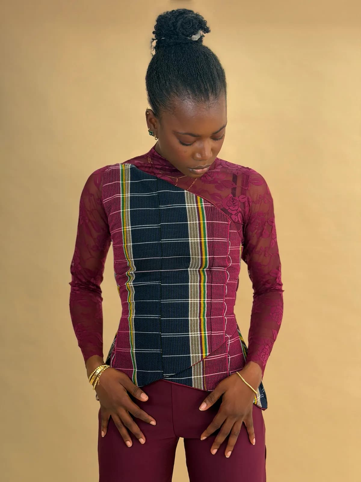 The Mono set worn with a burgundy lace overlay, striped Ètù bodice in focus