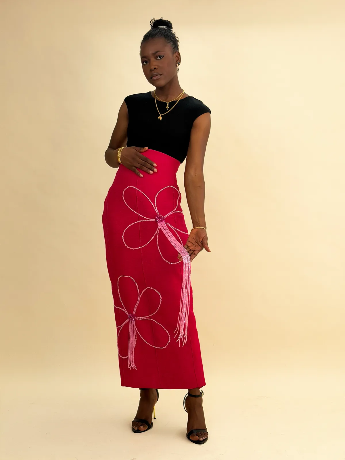 The Ododo skirt in plum, styled with a black off-shoulder top